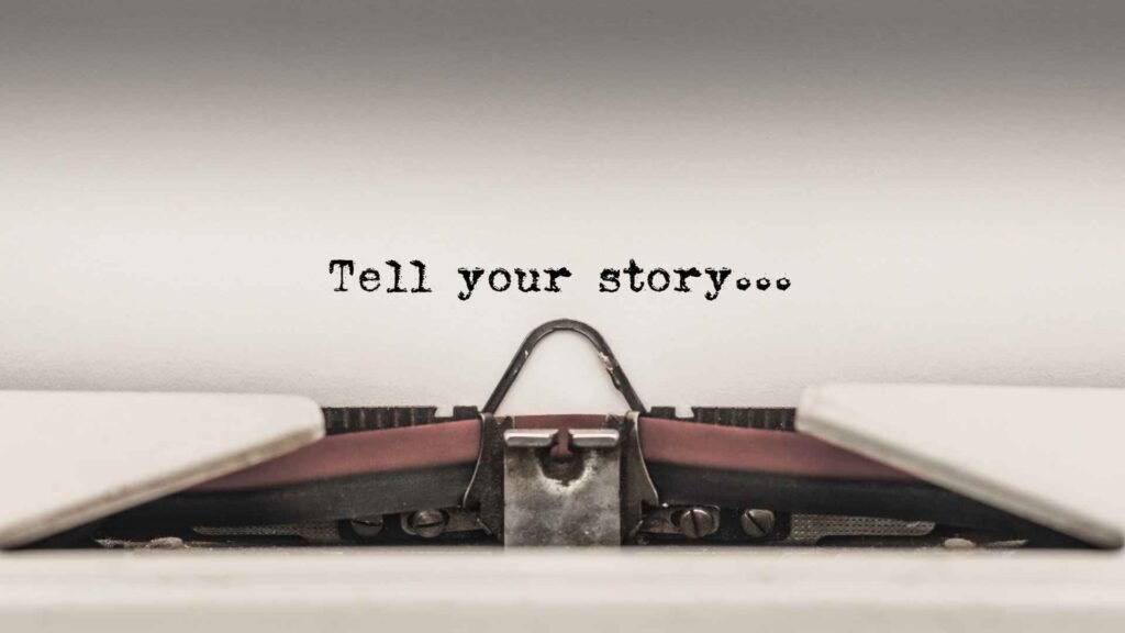 Typewriter with paper reading “Tell your story”