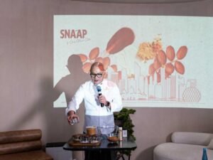 Chef Nouel Catis crafting the Abu Dhabi Chocolate in front of the SNA’AP Abu Dhabi launch backdrop.