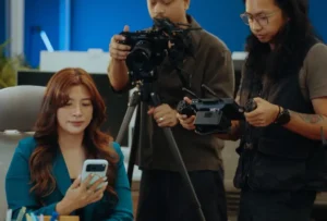 Sandbox Creatives team filming a UGC video in Dubai: camera operator, monitor and actor holding a phone